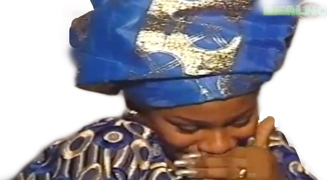 woman on gele chuckling